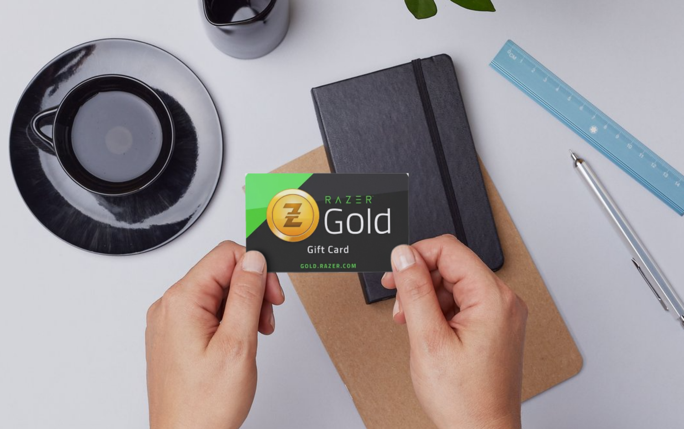 User holding a Razer Gold gift card