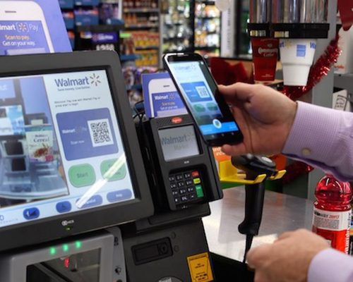 An image showing a customer making a payment with Walmart Pay.