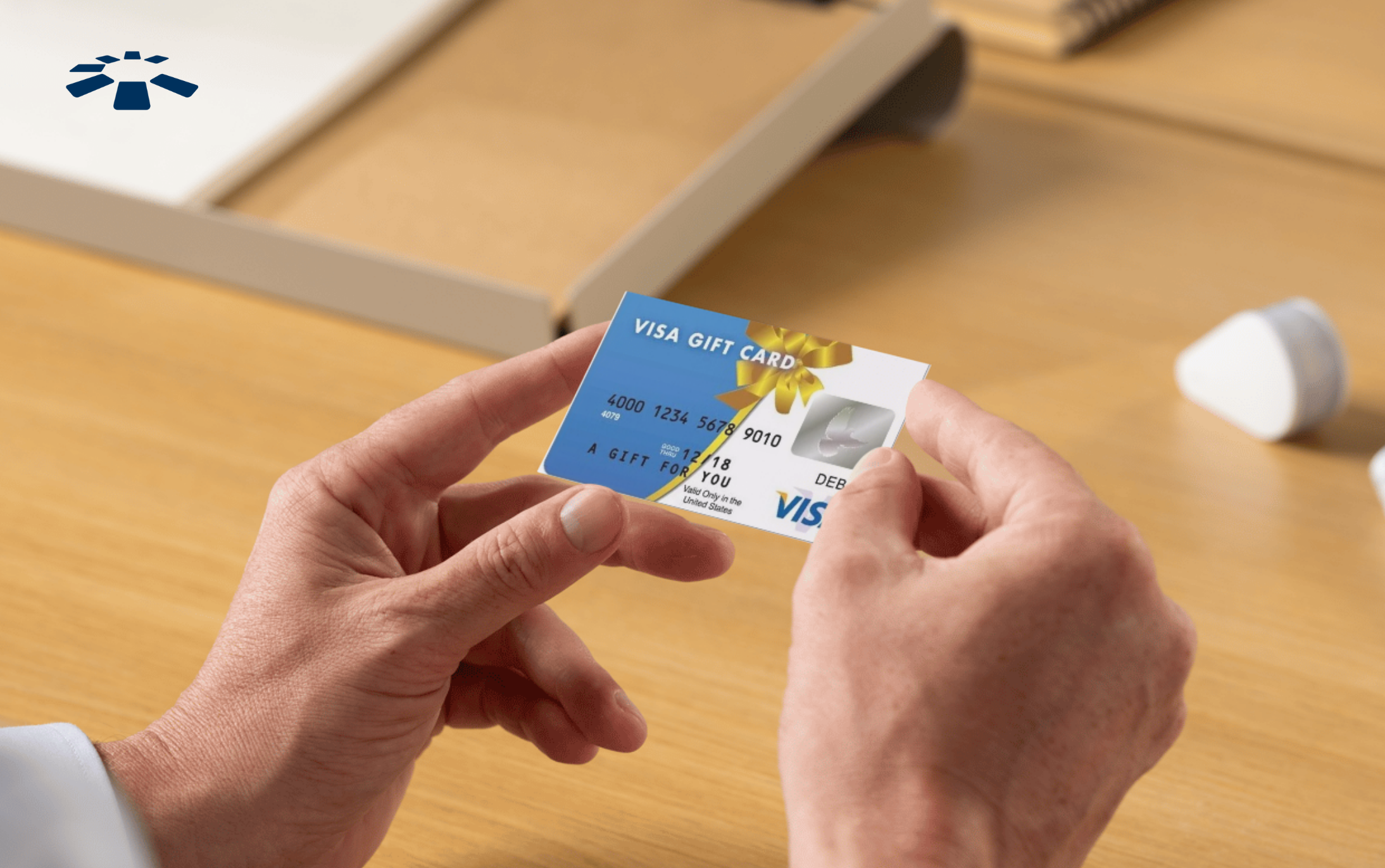 Man holding a Visa gift card