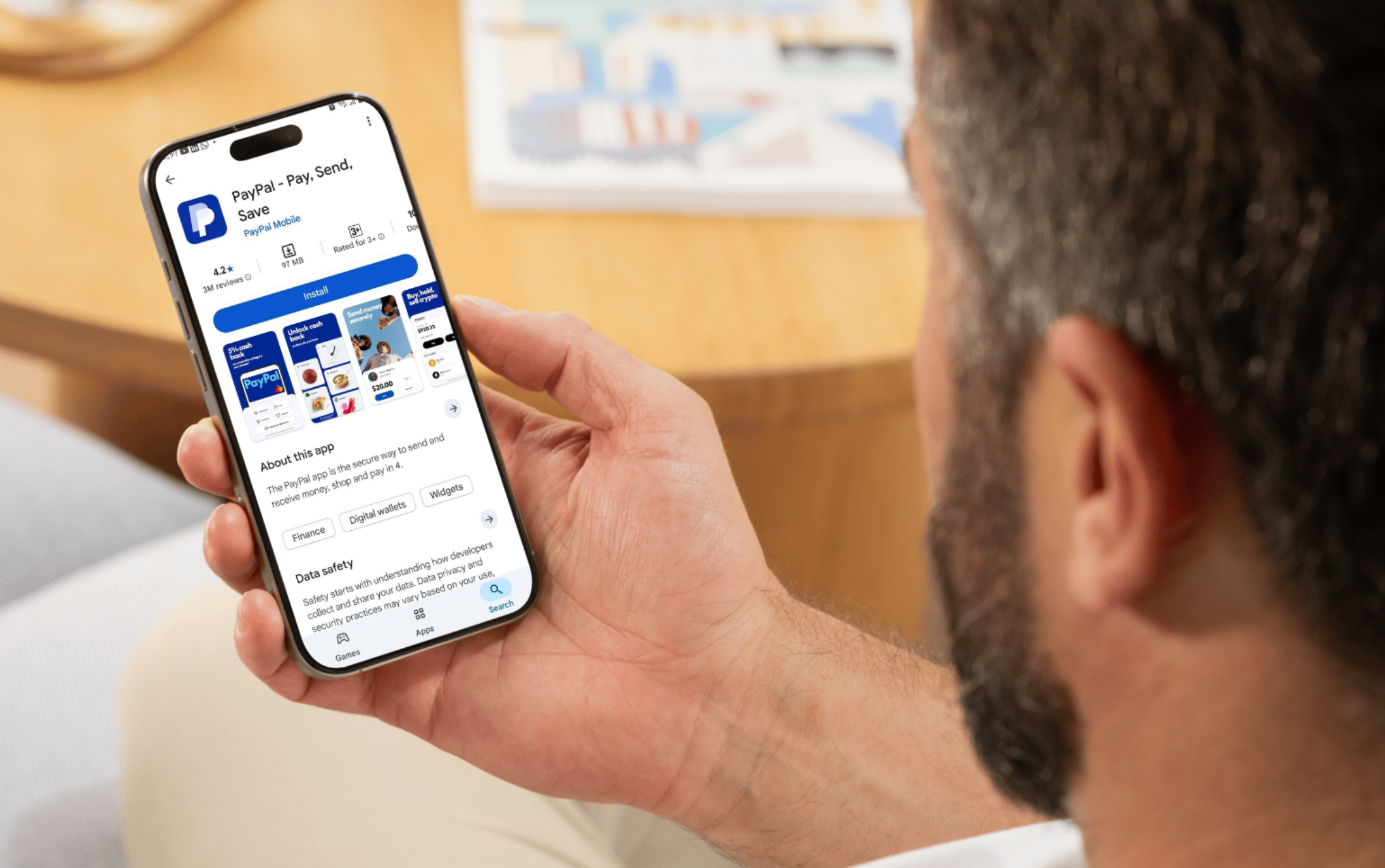 Man looking at the PayPal "Install" page on his phone